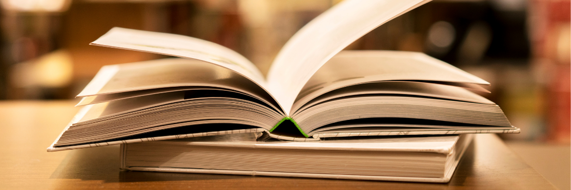 image of an open book sitting on top of a closed book