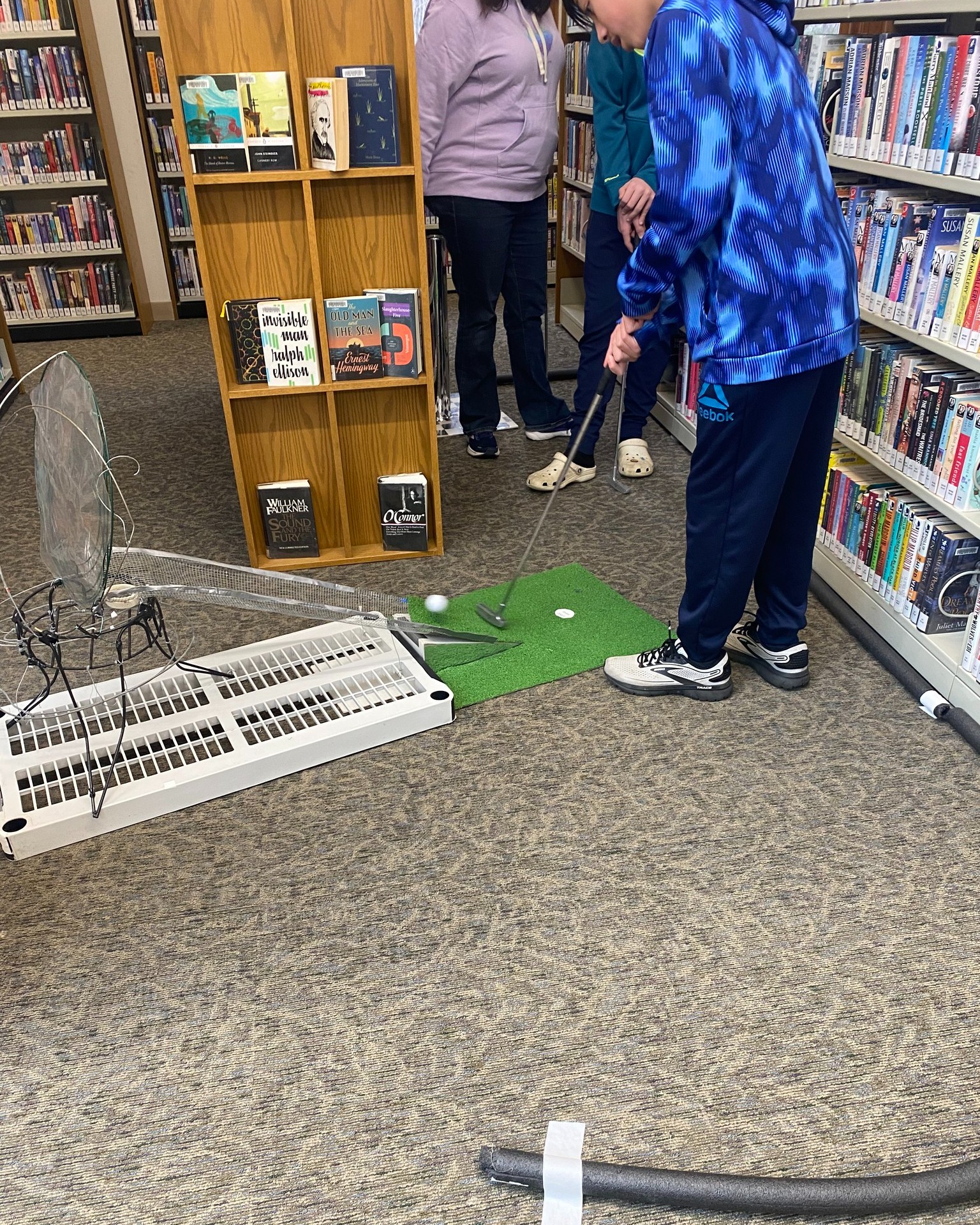 Person playing mini-golf hole