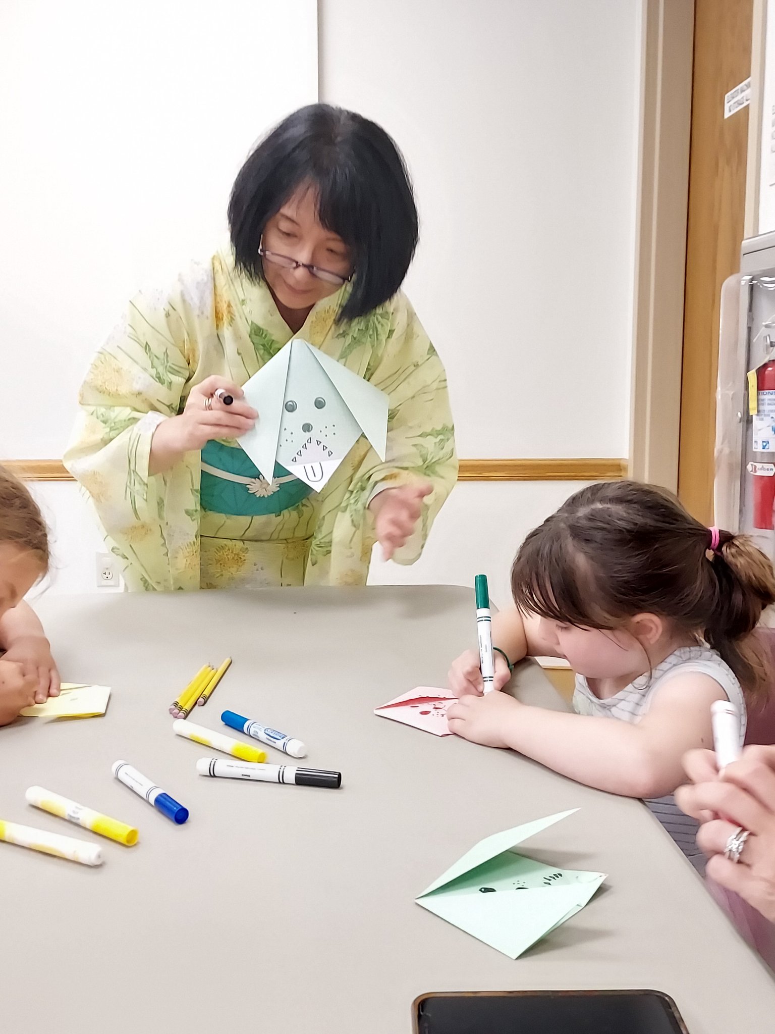 Origami Storigami Motoko showing group how to create origami pieces