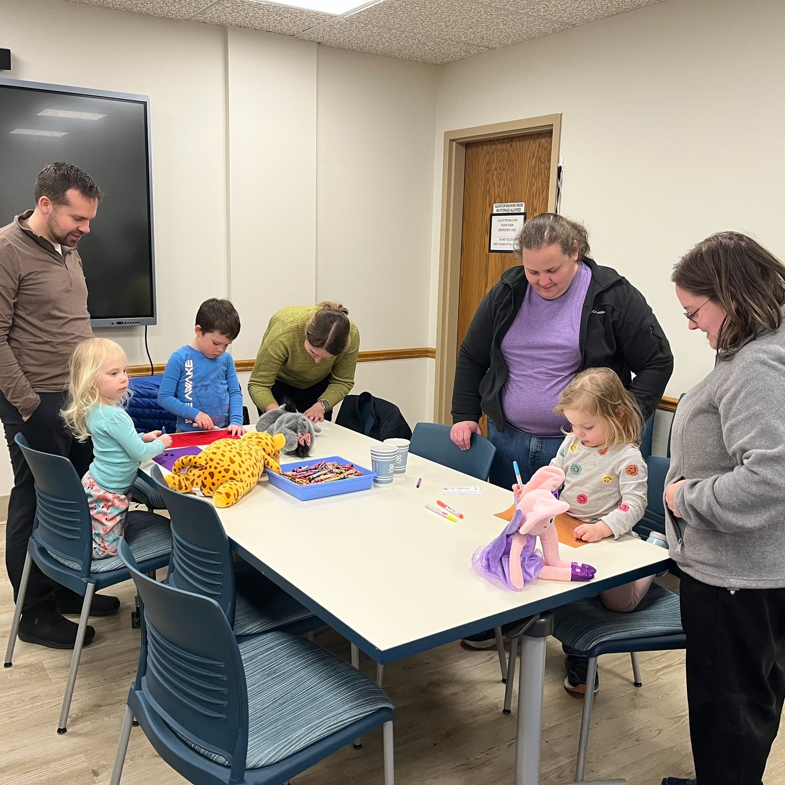 Little kids at table making signs