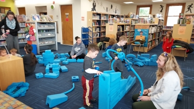 Room filled with blue building pieces (Imagination Playground)