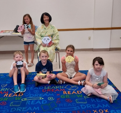 Origami Storigami - children holding up their finished origami pieces
