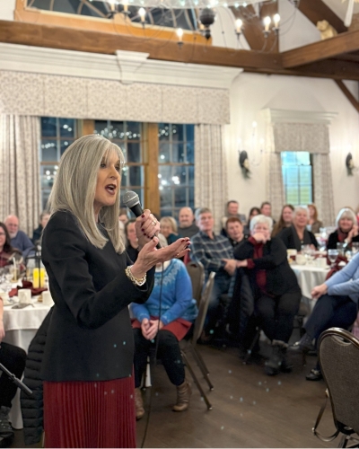 Speaker with microphone at Stewing Over Mysteries