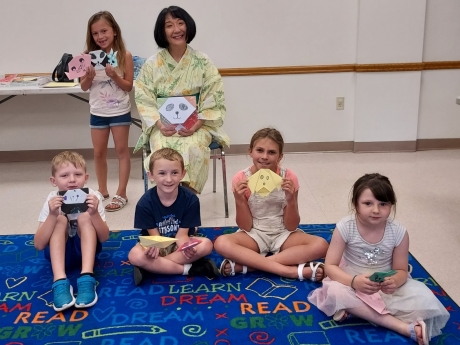 Origami Storigami - children holding up their finished origami pieces