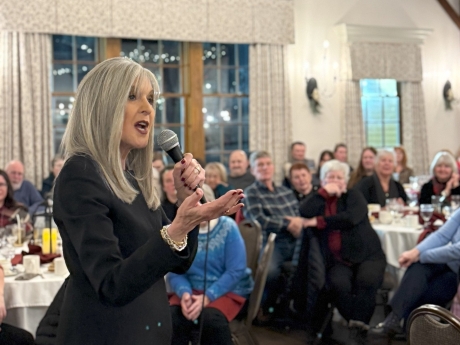 Speaker with microphone at Stewing Over Mysteries