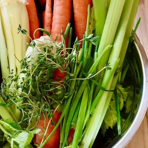 Assorted vegetables in a stainless steel bowl.
