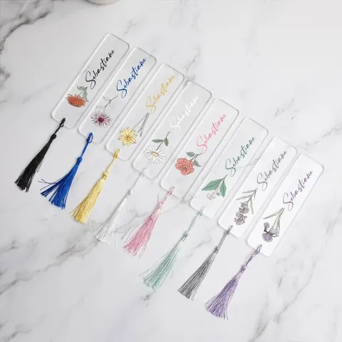 Elegant bookmarks with floral designs and colorful tassels.