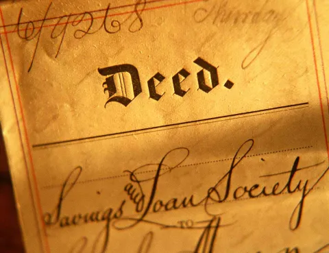 Piece of old paper with the word Deed written on it