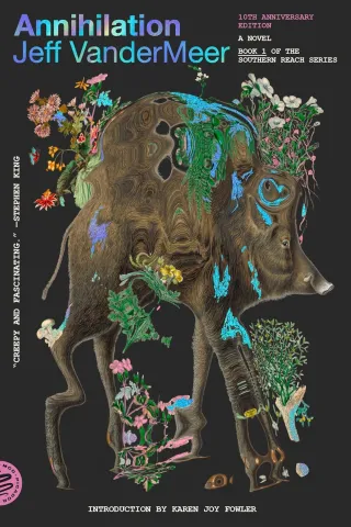 Surreal book cover for "Annihilation" by Jeff VanderMeer; features a distorted boar adorned with vibrant, eerie flowers, against a black background. The tone is mysterious and evocative.