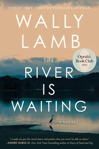 Book cover for "The River is Waiting" by Wally Lamb features a tranquil lake with a heron, silhouetted trees, and a serene sky, Oprah's Book Club 2025 pick.