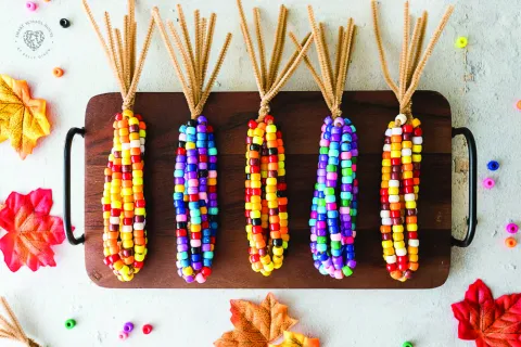 A tray of colorful handmade bead corn.