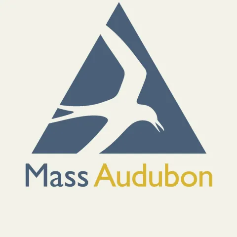 Logo of Mass Audubon showing a stylized blue bird in flight within a blue triangle, with "Mass Audubon" text below in blue and gold. Energetic, nature-focused design.