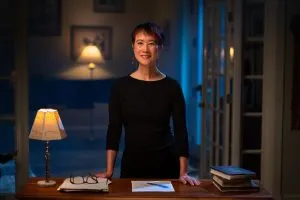 Photo of Tess Gerritsen standing at a desk