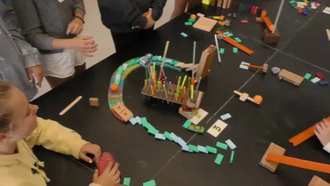 An example of a Rube Goldberg machine made by a child during this program.