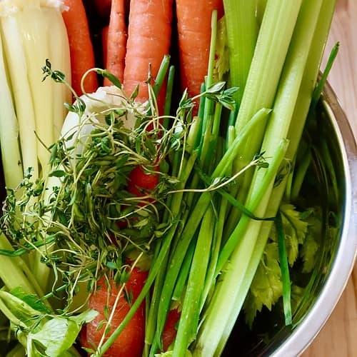 Assorted vegetables in a stainless steel bowl.