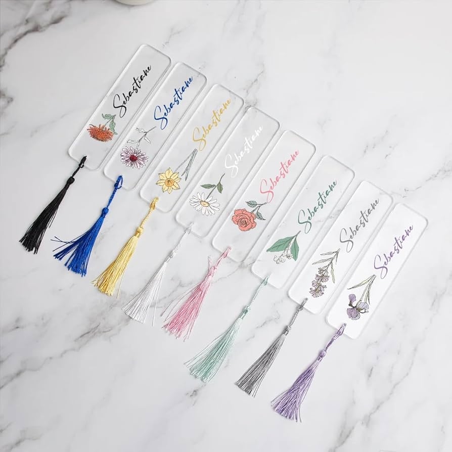 Elegant bookmarks with floral designs and colorful tassels.