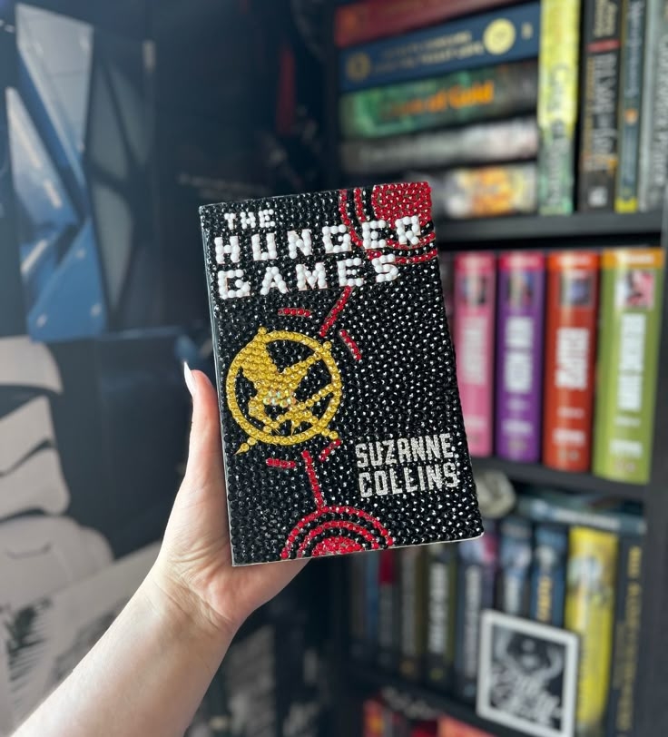 A bedazzled copy of The Hunger Games by Suzanne Collins.