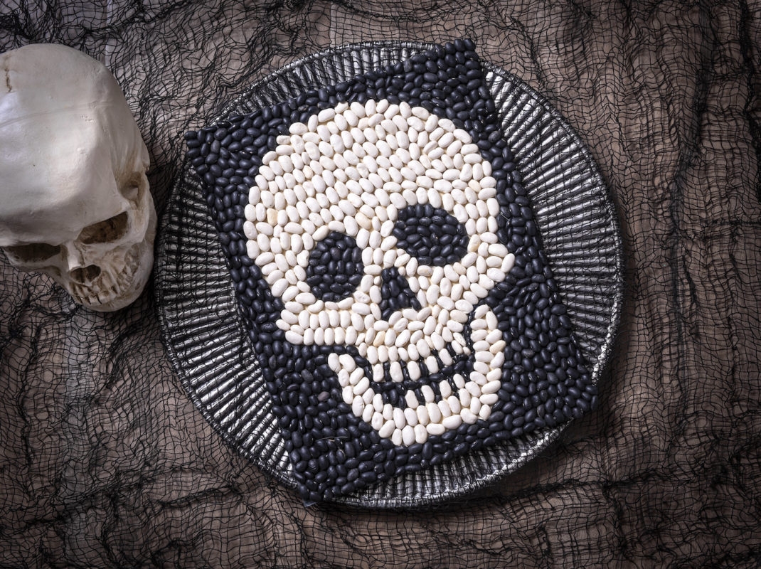 A skull made out of white and black beans.
