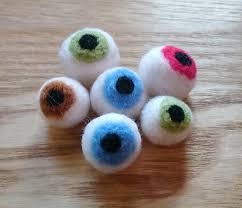 A collection of needle felted wool eyeballs.