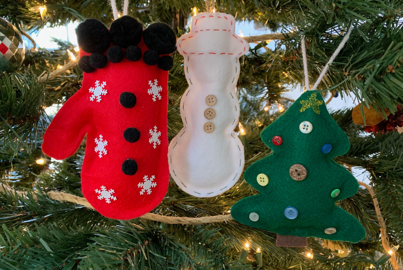 Felt ornaments hanging on a tree.
