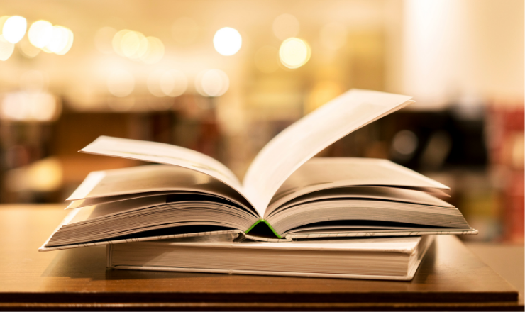Photo of an open book sitting on a desk